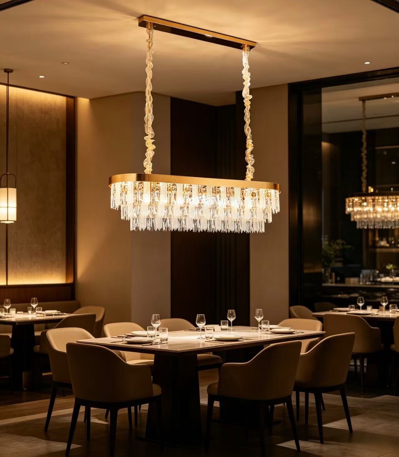 Crystal and brass linear chandelier over a restaurant table