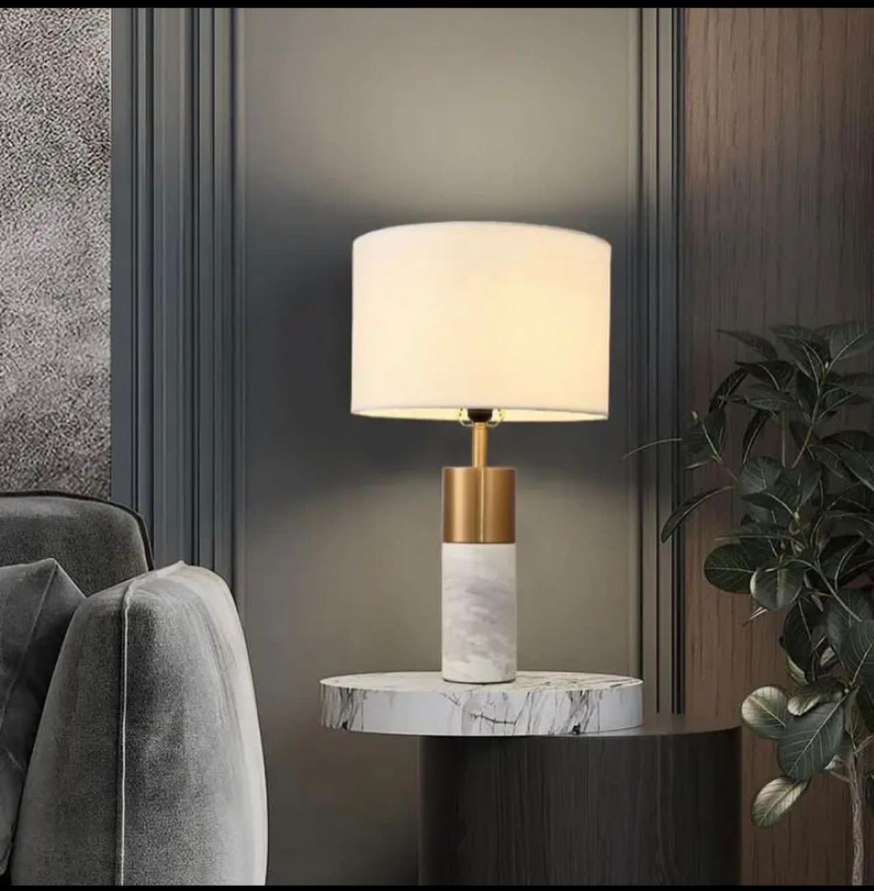 Marble and brass table lamp beside a armchair