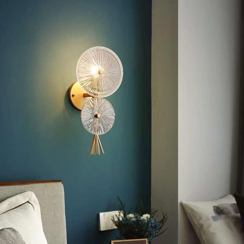 Pair of fluted wall lights on a deep teal bedroom wall